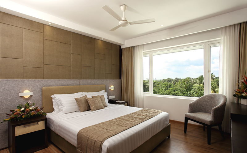 Elegant bedroom at Sugar Business Hotel with modern interiors, premium bedding, ambient lighting, and contemporary business-class comfort.